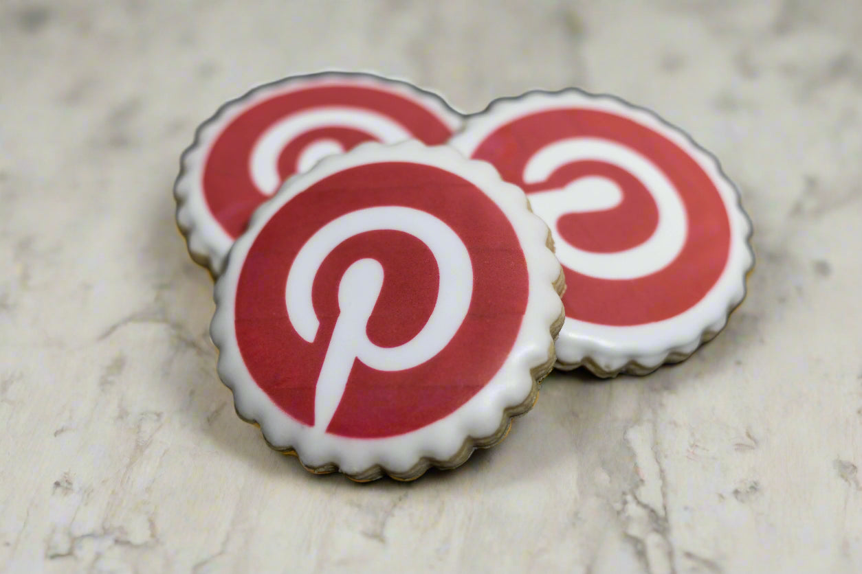 Round scalloped sugar cookie with Pinterest logo printed on white icing