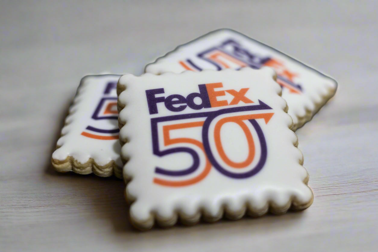 Square scalloped cookie with FedEx Celebrates 50 Years Logo printed on white icing.