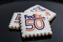 Load image into Gallery viewer, Square scalloped cookie with FedEx Celebrates 50 Years Logo printed on white icing.