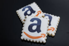 Load image into Gallery viewer, Square scalloped cookie with Amazon logo and smile printed on white icing.