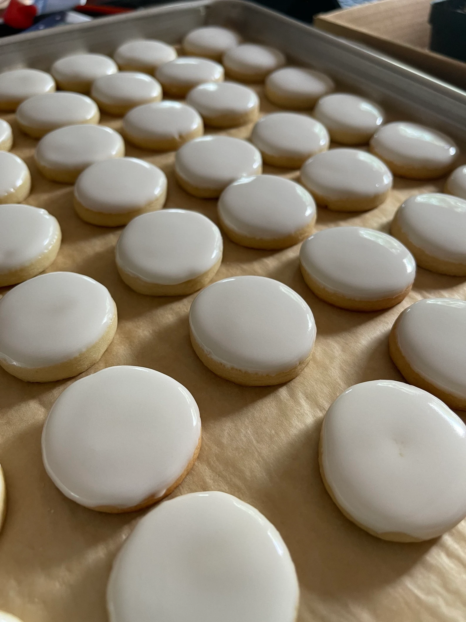 Freshly iced sugar cookies cooling on the tray